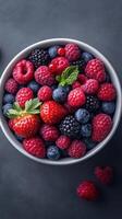 Colorful assortment of fresh berries in a bowl ready for a healthy snack or dessert photo