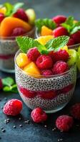 Fresh fruit chia pudding topped with raspberries and mint on a dark background during daylight hours photo