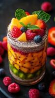 Colorful fruit parfait layered with fresh berries and tropical fruits in a gourmet presentation photo