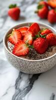 Delicious bowl of chia seed pudding topped with fresh strawberries on a marble surface photo