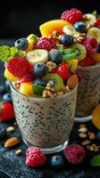 Delicious and vibrant fruit parfait with granola and seeds served in clear glasses photo