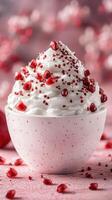 Delicious whipped cream topped with pomegranate seeds in a decorative bowl on a pink backdrop photo