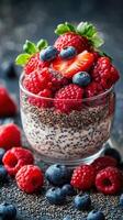 Delicious berry chia pudding topped with fresh strawberries, blueberries, and raspberries in a clear glass photo