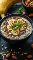 Healthy breakfast bowl with banana, nuts, and chia seeds prepared in a cozy kitchen photo