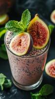 Fresh fig smoothie with mint garnish served in a glass on a dark surface with sliced figs and mint leaves photo