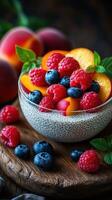 Delicious chia pudding topped with fresh raspberries, blueberries, and peach slices on a wooden table photo