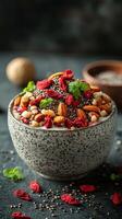 Healthy breakfast bowl filled with nuts, seeds, and dried fruits on a dark surface photo