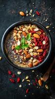 Healthy breakfast bowl featuring nuts, seeds, and goji berries arranged beautifully on a dark background photo
