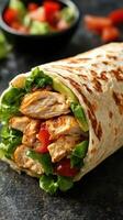 Grilled chicken wrap filled with fresh vegetables served with a side of diced tomatoes photo