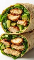 Grilled chicken wrap filled with fresh vegetables and greens served on a white background photo