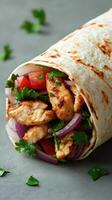 Delicious chicken wrap filled with fresh vegetables and herbs, perfect for a quick meal photo
