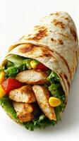 Freshly made chicken wrap filled with vibrant vegetables and wrapped in warm flatbread photo