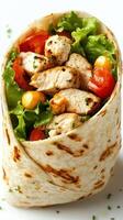 Fresh grilled chicken wrap with lettuce, tomatoes, and corn in a soft tortilla for a healthy meal option photo