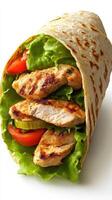Grilled chicken wrap filled with fresh lettuce and tomatoes ready to be enjoyed for lunch photo
