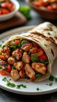 Grilled chicken wrap filled with fresh vegetables and herbs on a plate with vibrant side salad photo