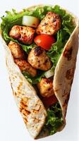 Delicious chicken wrap filled with fresh vegetables and grilled meat ready to eat at lunchtime photo