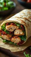 Delicious chicken wrap filled with fresh greens and sun-dried tomatoes on a wooden surface photo
