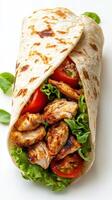 Delicious grilled chicken wrap with fresh vegetables and herbs served on a clean plate photo