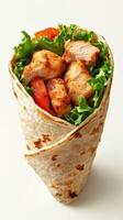 Grilled chicken wrap filled with fresh lettuce and tomatoes served on a clean background photo