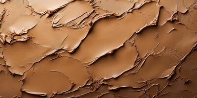 Smooth and textured brown plaster with organic patterns on a surface in natural lighting photo