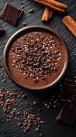 Deliciously rich hot chocolate with chocolate chips and cinnamon on a textured dark background photo