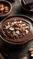 Creamy chocolate dessert topped with almonds and chocolate chips served in a rustic bowl photo