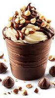 Delicious chocolate and vanilla swirl dessert topped with nuts served in a cup photo