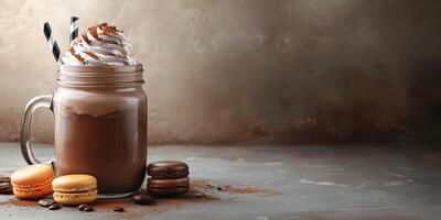 Indulgent chocolate beverage topped with whipped cream and macarons on a rustic table photo