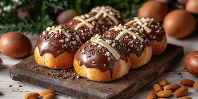 Delicious chocolate topped pastries with nuts and eggs arranged on a rustic wooden board for a festive celebration photo