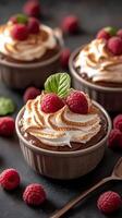 Delicious chocolate mousse topped with fresh raspberries in elegant serving bowls photo