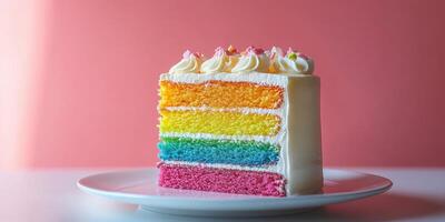Colorful layered cake displayed on a plate against a vibrant pink background photo