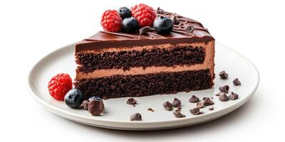 Chocolate cake slice topped with fresh berries and chocolate chips on a white plate photo