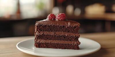 Decadent chocolate cake served on a plate with fresh raspberries in a cozy cafe setting photo