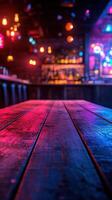 Vibrant bar interior with colorful lights and wooden table at night photo