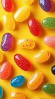 Colorful jelly beans scattered on bright yellow background create a vibrant and playful candy display for festive occasions photo