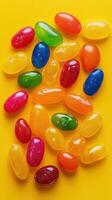 Colorful assortment of jelly beans arranged on a vibrant yellow background for a cheerful treat photo