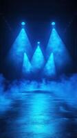 Blue lighting illuminates a foggy stage preparing for a live performance in a darkened venue photo