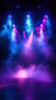 Colorful stage lights create a dramatic atmosphere in a darkened venue during a live performance photo