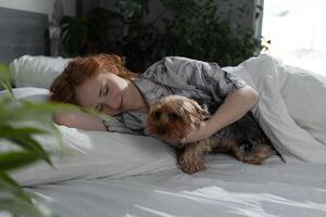 Cozy Morning A Woman Snuggling Enthusiastically with Her Dog While Relaxing in Bed photo
