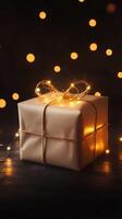 Gift box wrapped in brown paper with twinkling lights during a festive celebration in a cozy indoor setting photo