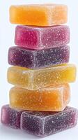 Colorful gummy candies stacked in a tower on a white background showcasing their glossy texture and vibrant hues photo