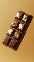 Luxurious chocolate bar adorned with shiny gold pieces against an elegant golden background photo
