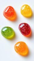 Colorful gummy candies arranged on a white surface, showcasing vibrant hues and shapes photo