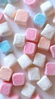 Colorful marshmallows scattered on a white surface create a sweet and vibrant display perfect for dessert decorating photo