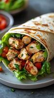 Grilled chicken wrap with fresh vegetables served on a plate during lunch time photo