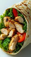 Grilled chicken wrap featuring fresh lettuce and tomatoes served in a soft tortilla for a healthy meal photo