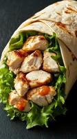 Delicious grilled chicken wrap with fresh lettuce and spicy sauce prepared for a satisfying meal at lunchtime photo