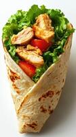 Delicious chicken wrap with fresh lettuce and tomatoes served in a soft tortilla photo