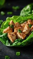 Savory chicken salad served in fresh lettuce cups with a sprinkle of green onion photo