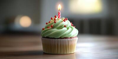 Delicious cupcake with green frosting and a candle decorated with red sprinkles on a wooden table at a cozy setting photo